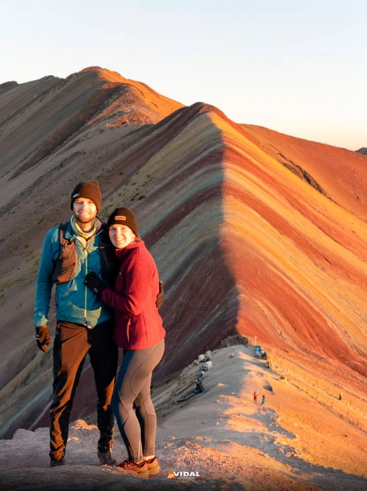 Happy couple in the Rainbow Mountain Sunset